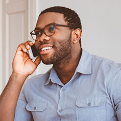 man talking on cell phone while smiling