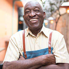 man laughing with arms crossed