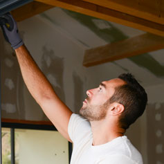 man with hand raised towards ceiling