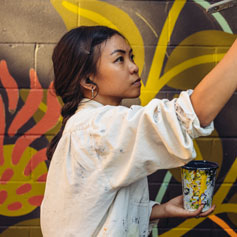 woman painting on a wall